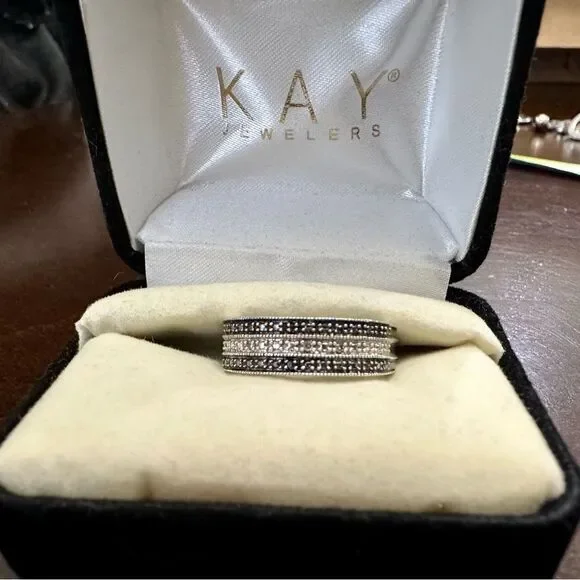 Sterling silver band with small diamond chips.